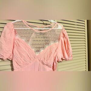 Shorts from the bottom. Pink. White. Buttons and zipper in the back.